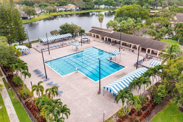 view of pool featuring a patio area and a water view