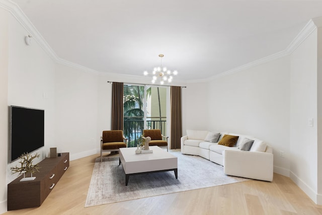 living room featuring ornamental molding, a chandelier, and light hardwood / wood-style flooring