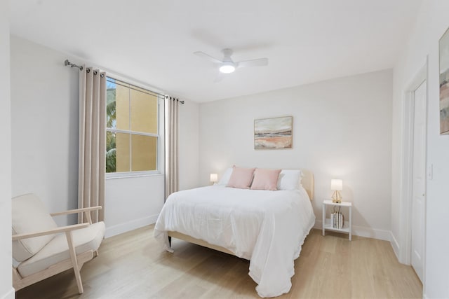 bedroom with ceiling fan and light wood-type flooring