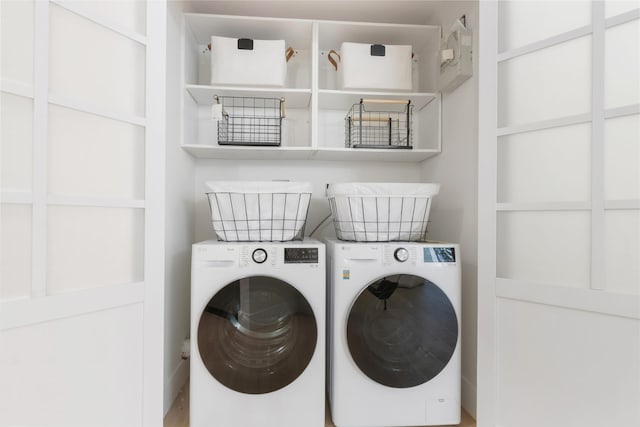 clothes washing area featuring washer and clothes dryer