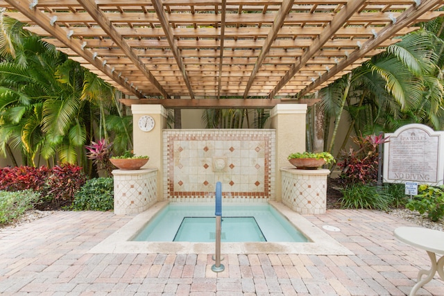 view of swimming pool featuring a community hot tub and a pergola