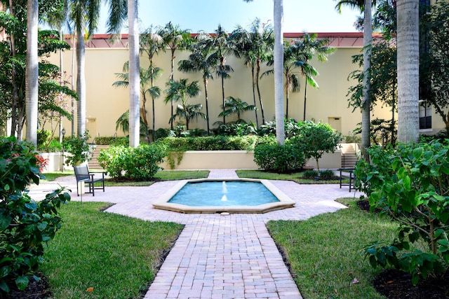 view of pool featuring a yard and a patio area