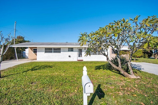 ranch-style home with a carport and a front yard