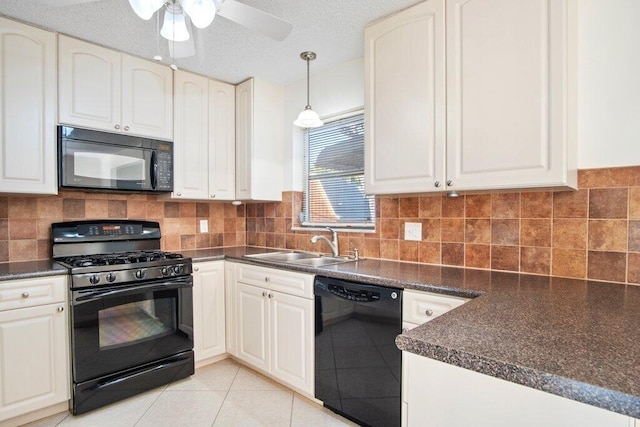 kitchen with black appliances, pendant lighting, white cabinets, and light tile patterned floors