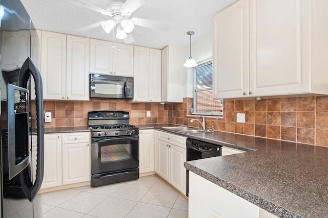 kitchen featuring backsplash, black appliances, sink, hanging light fixtures, and ceiling fan