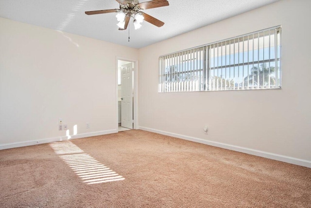 spare room with ceiling fan, a healthy amount of sunlight, and carpet floors