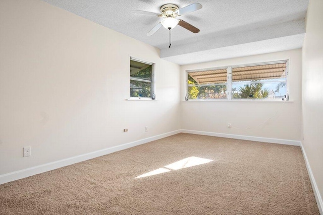 carpeted spare room with ceiling fan and a textured ceiling