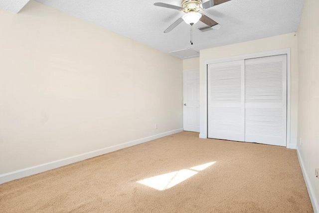 unfurnished bedroom with carpet flooring, ceiling fan, and a closet