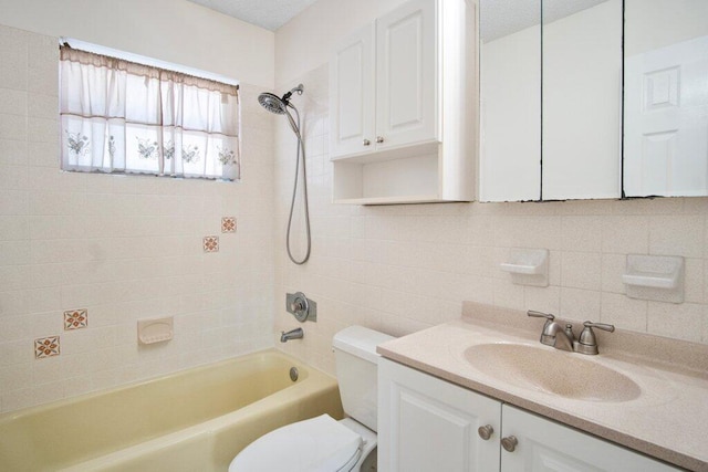 full bathroom featuring decorative backsplash, vanity, tiled shower / bath combo, and toilet