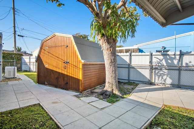 view of home's exterior with central AC unit and a storage unit