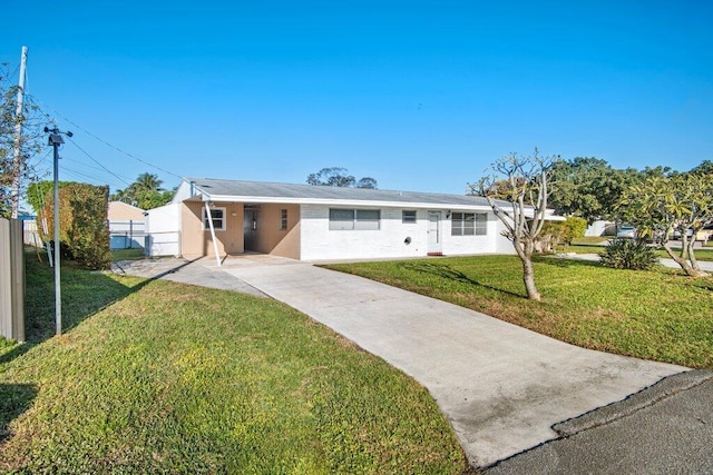 single story home featuring a carport and a front yard