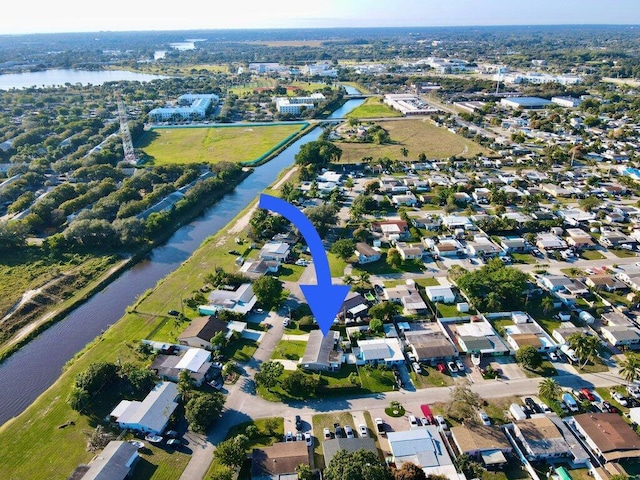 drone / aerial view featuring a residential view and a water view