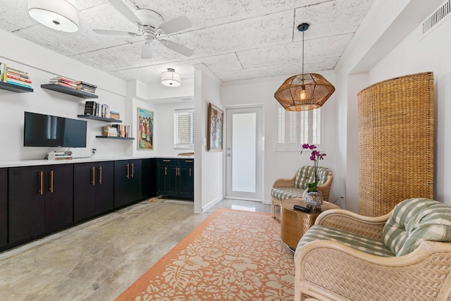 kitchen with decorative light fixtures, ceiling fan, and a wealth of natural light