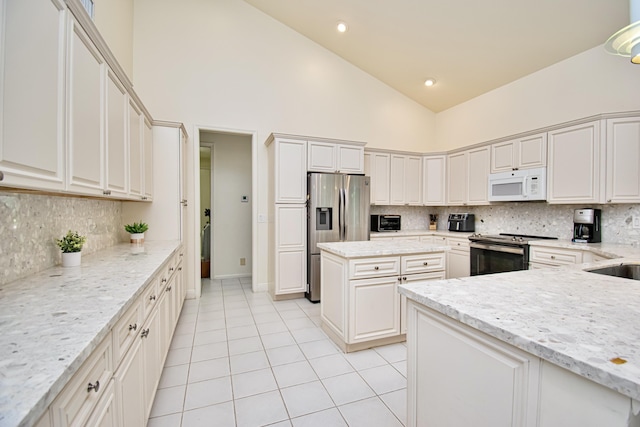 kitchen featuring appliances with stainless steel finishes, white cabinets, high vaulted ceiling, light stone counters, and light tile patterned flooring