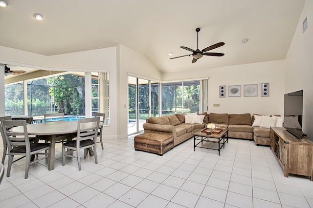 living room featuring vaulted ceiling, ceiling fan, and light tile patterned flooring