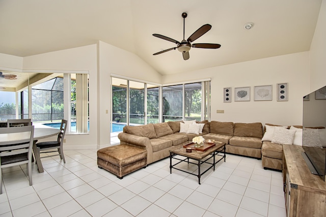 living room featuring ceiling fan, light tile patterned floors, and lofted ceiling