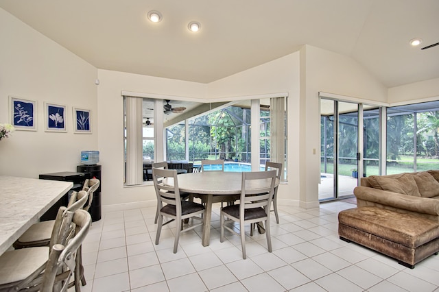 dining area with ceiling fan, light tile patterned floors, and lofted ceiling