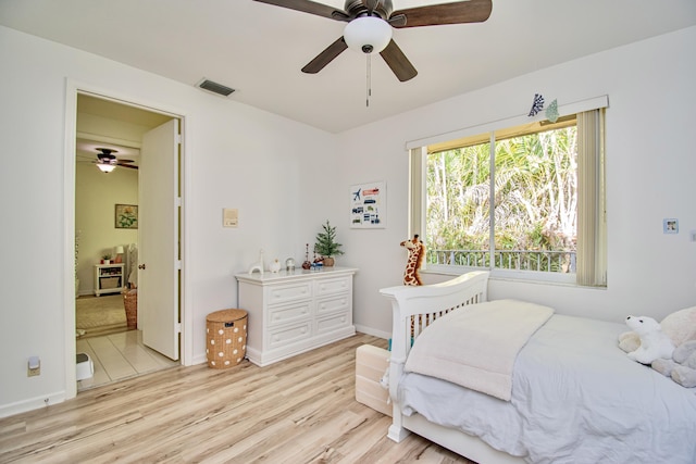 bedroom with light wood-type flooring and ceiling fan