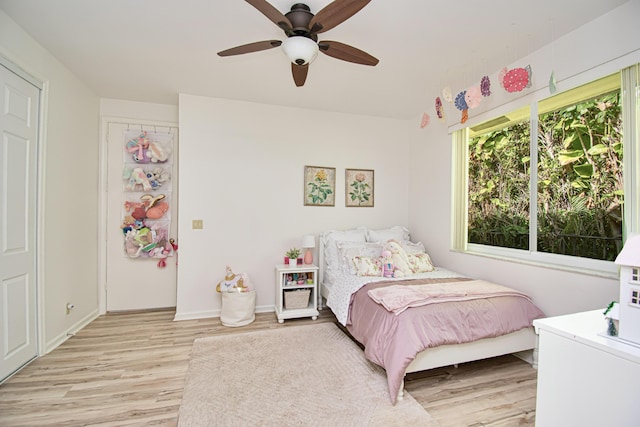 bedroom with light wood-type flooring and ceiling fan