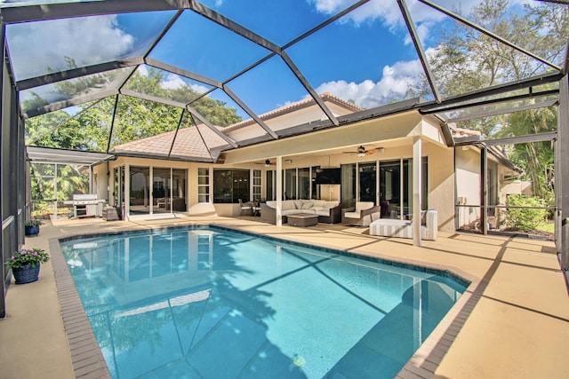 view of swimming pool featuring ceiling fan, a patio area, a lanai, and an outdoor hangout area