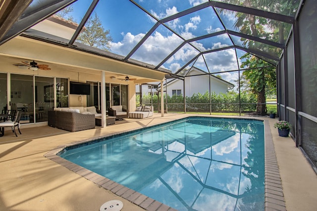 view of swimming pool featuring glass enclosure, outdoor lounge area, ceiling fan, and a patio