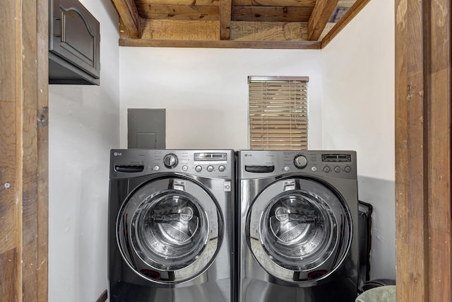 washroom with cabinets, wood ceiling, and washing machine and clothes dryer