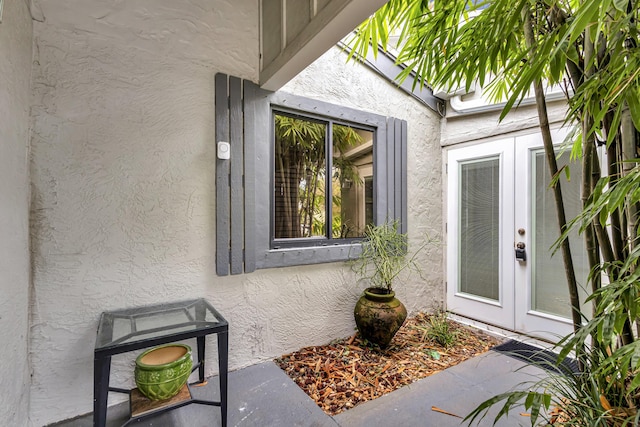 entrance to property with french doors and stucco siding