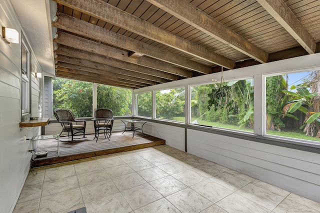 unfurnished sunroom with wood ceiling and beamed ceiling