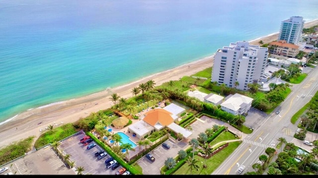 birds eye view of property with a beach view and a water view