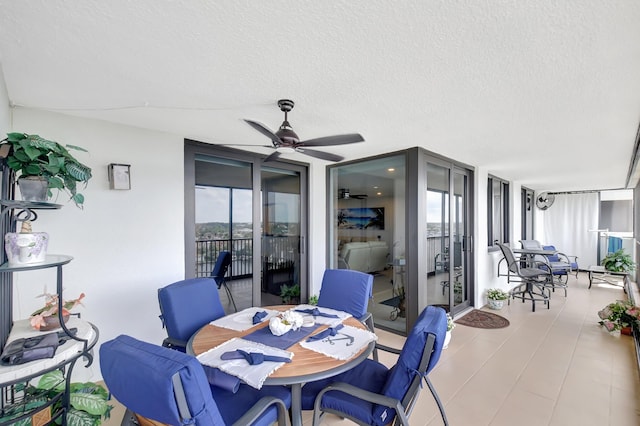 dining area featuring a textured ceiling, ceiling fan, and expansive windows