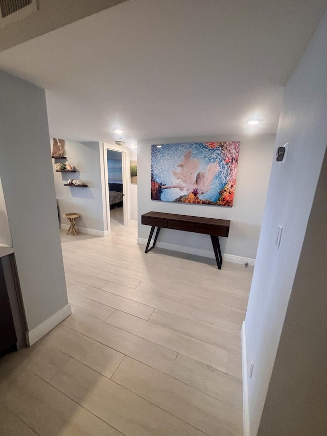 hallway with light hardwood / wood-style flooring