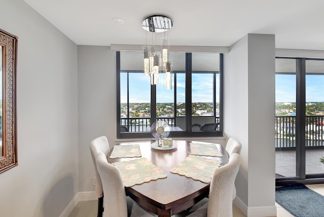 dining area featuring floor to ceiling windows and a chandelier