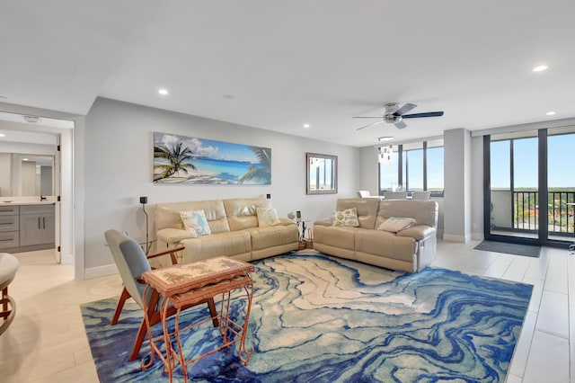 living room featuring ceiling fan, light hardwood / wood-style flooring, and floor to ceiling windows