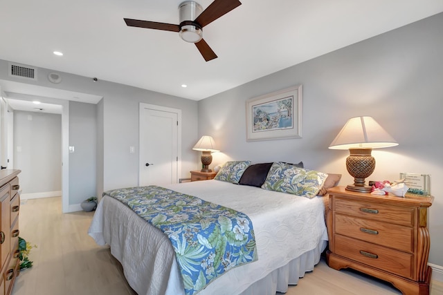 bedroom with ceiling fan and light hardwood / wood-style floors