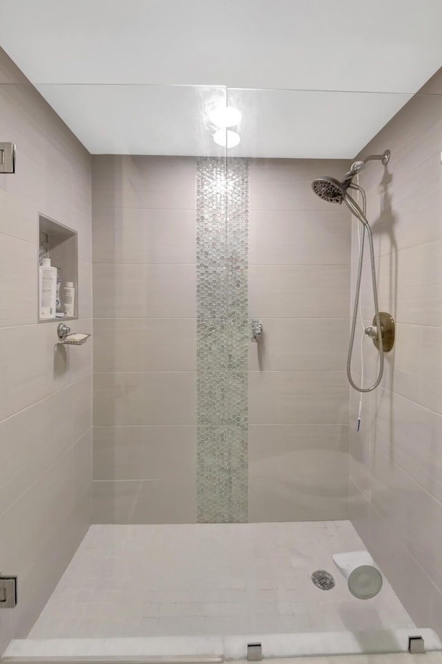 bathroom featuring a shower with shower door