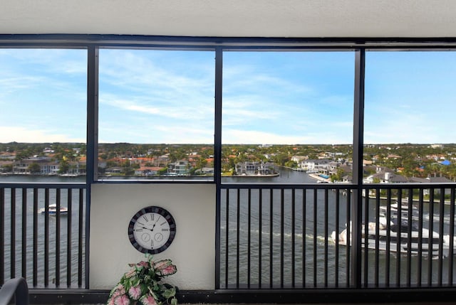 unfurnished sunroom featuring a water view