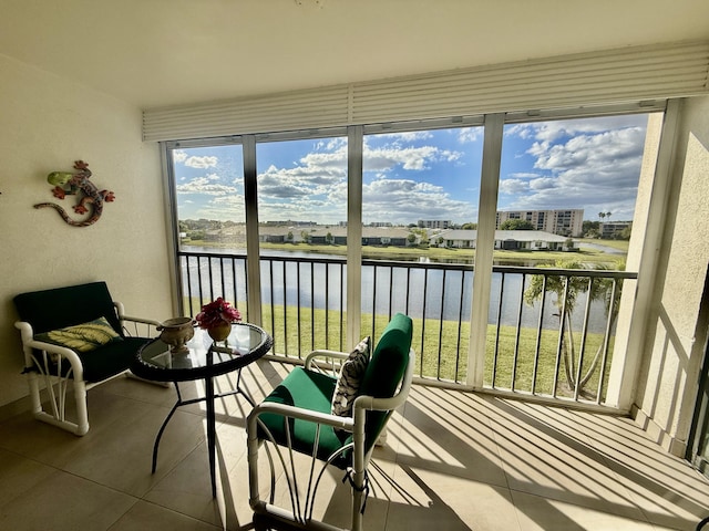 sunroom featuring a water view and a healthy amount of sunlight