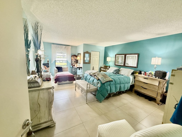 bedroom with light tile patterned floors and a textured ceiling