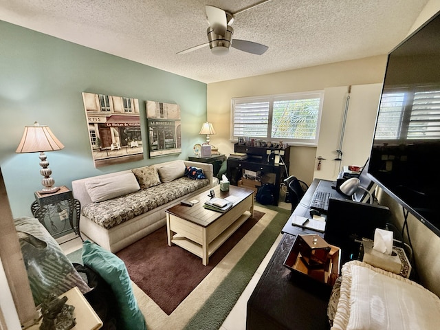 carpeted living room with ceiling fan and a textured ceiling