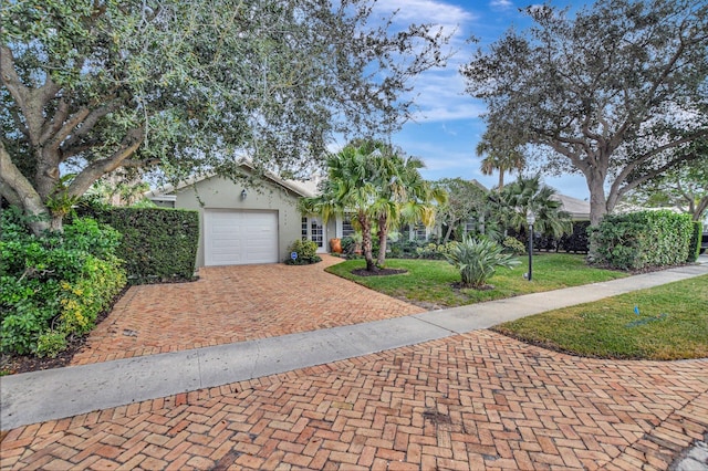 view of front of home featuring a front yard and a garage