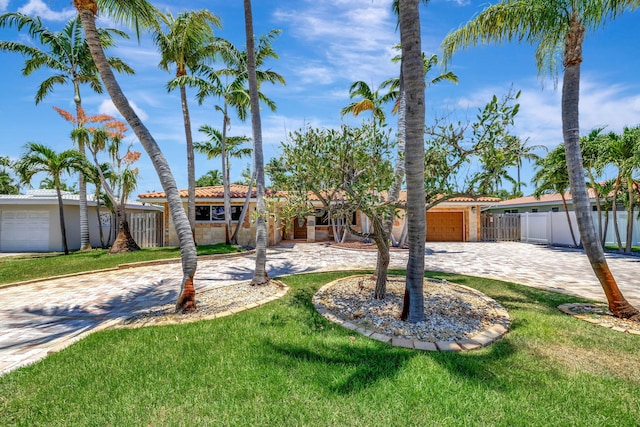 view of front of house featuring a front yard and a garage