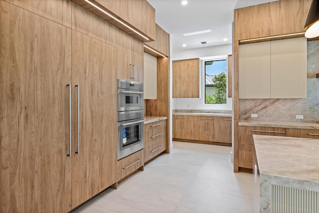 3100 Palm Dr, Delray Beach, FL 33483 - kitchen with recessed lighting, backsplash, modern cabinets, stainless steel double oven, and light countertops