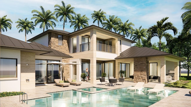 rear view of house featuring a pool with hot tub and a patio area