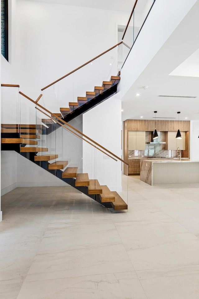 3100 Palm Dr, Delray Beach, FL 33483 - stairway featuring a towering ceiling and recessed lighting