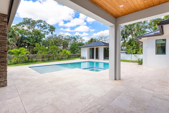3100 Palm Dr, Delray Beach, FL 33483 - view of swimming pool featuring a fenced backyard, an outdoor structure, a patio area, and a pool with connected hot tub