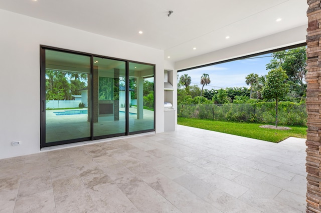 3100 Palm Dr, Delray Beach, FL 33483 - empty room featuring a wealth of natural light, recessed lighting, and stone finish flooring