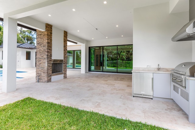 3100 Palm Dr, Delray Beach, FL 33483 - view of patio / terrace featuring an outdoor pool, an outdoor stone fireplace, a sink, and area for grilling