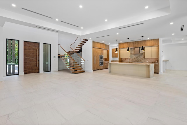 3100 Palm Dr, Delray Beach, FL 33483 - unfurnished living room with a sink, marble finish floor, recessed lighting, and stairway