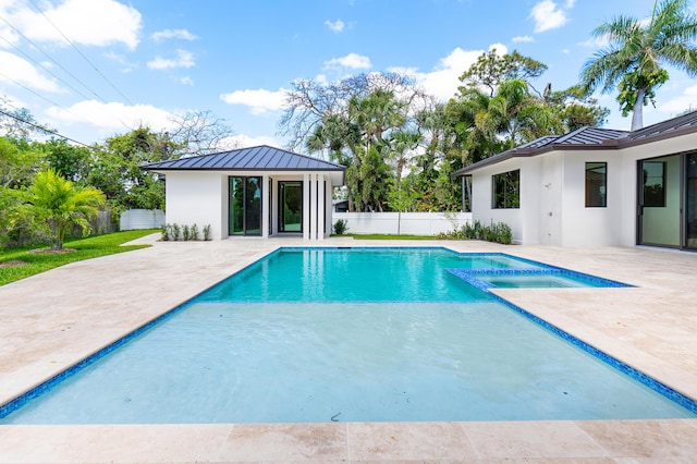 3100 Palm Dr, Delray Beach, FL 33483 - view of swimming pool with a fenced backyard, an outbuilding, a pool with connected hot tub, and a patio