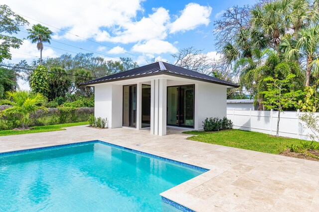 3100 Palm Dr, Delray Beach, FL 33483 - back of house featuring stucco siding, a patio, a fenced in pool, and metal roof